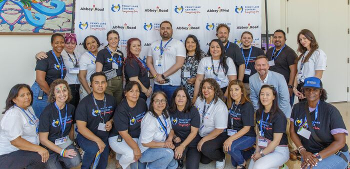Large group photo of conference staff in matching shirts and lanyards